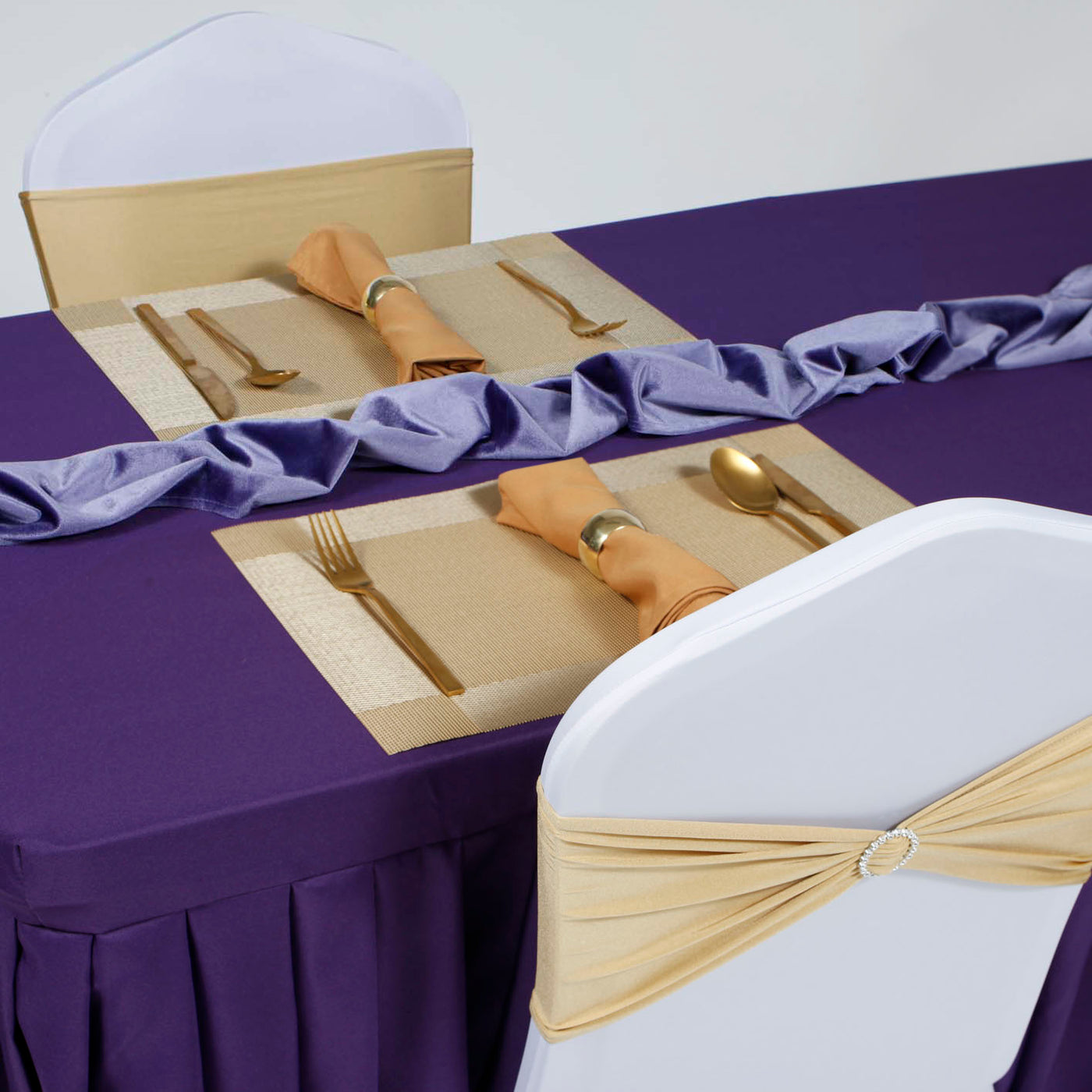 Gold placemat and purple linen event setup