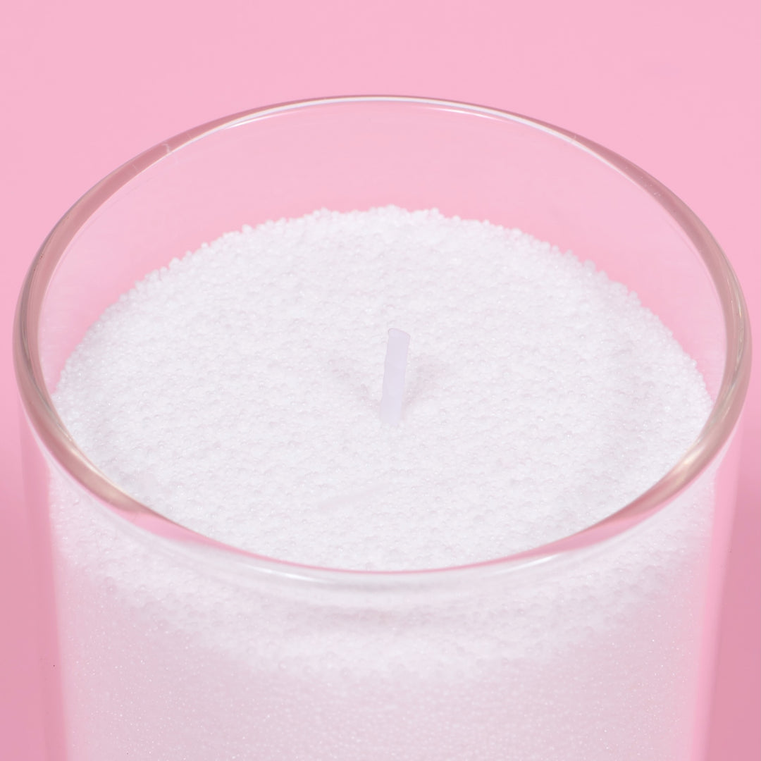 Close up of candle sand in vase with wick