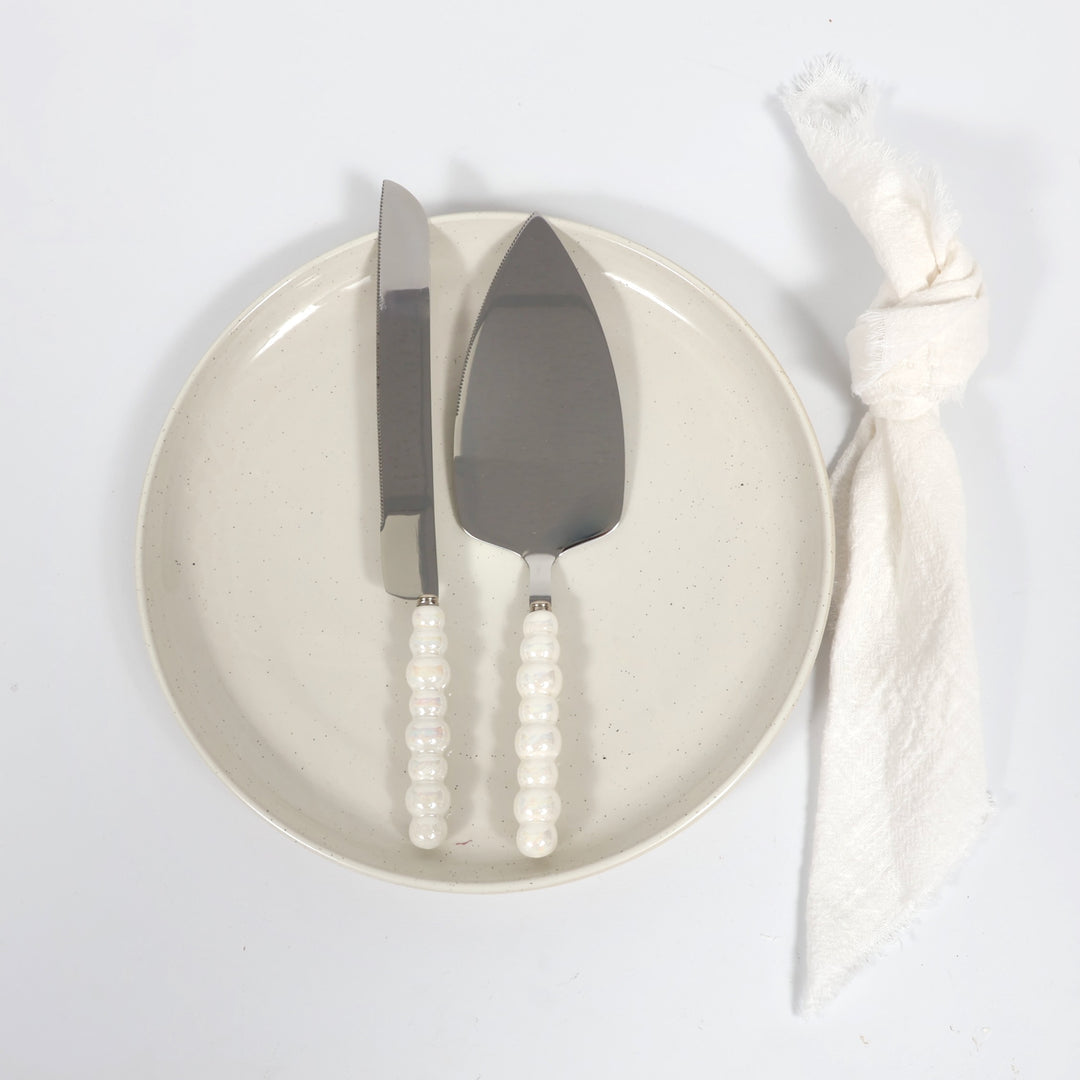 Cake Knife & Server Set - Bubble Handle - Silver (2pc), sitting on a plate with napkin next to it