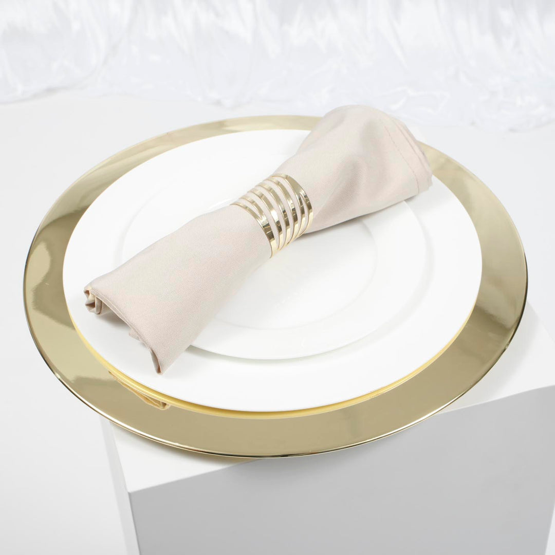 Gold Mirror Charger plate with white dinner plate ontop with linen napkin and gold napkin ringnd