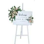 white display easel with example welcome sign and artificial flower garlands