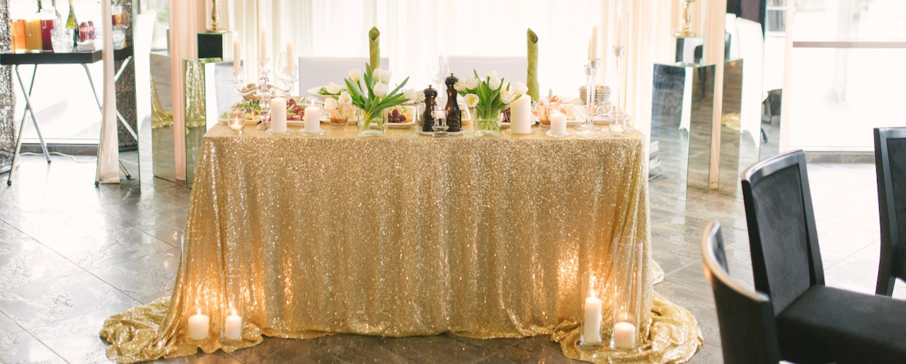 Gold sequin tablecloth on round cocktail table