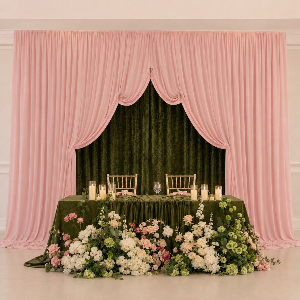 Double layered backdrop with Olive Green Velvet 3x3 behind the light pink lycra backdrop panels. A green table with candles and flowers sits in front