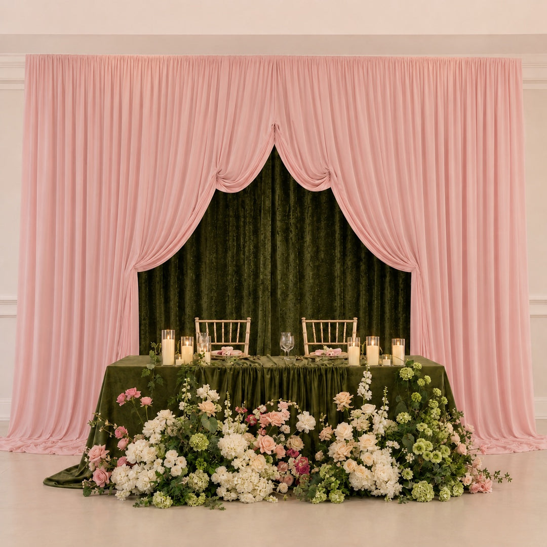 Double layered backdrop with Olive Green Velvet 3x3 behind the light pink lycra backdrop panels. A green table with candles and flowers sits in front