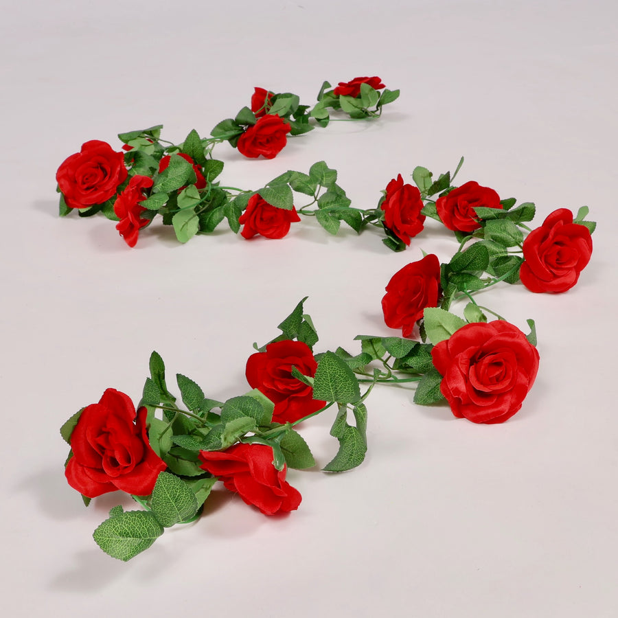 Artificial red rose garland on a light gray background
