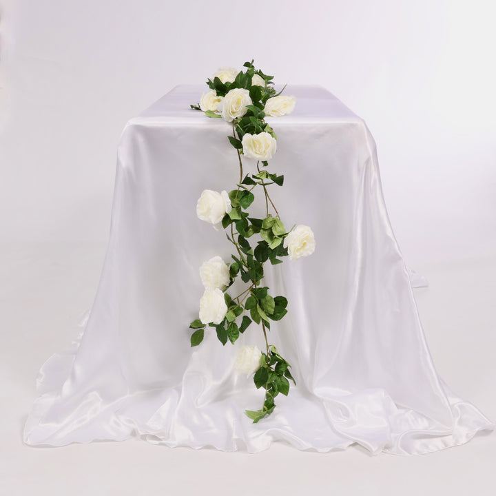 White tablecloth with a floral arrangement on a plain background