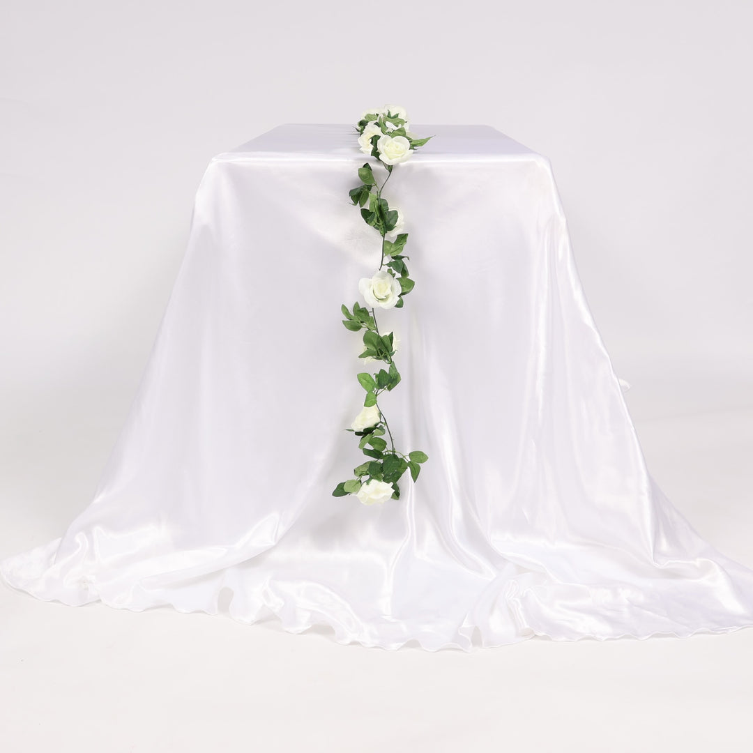 White tablecloth with a floral garland on a plain background
