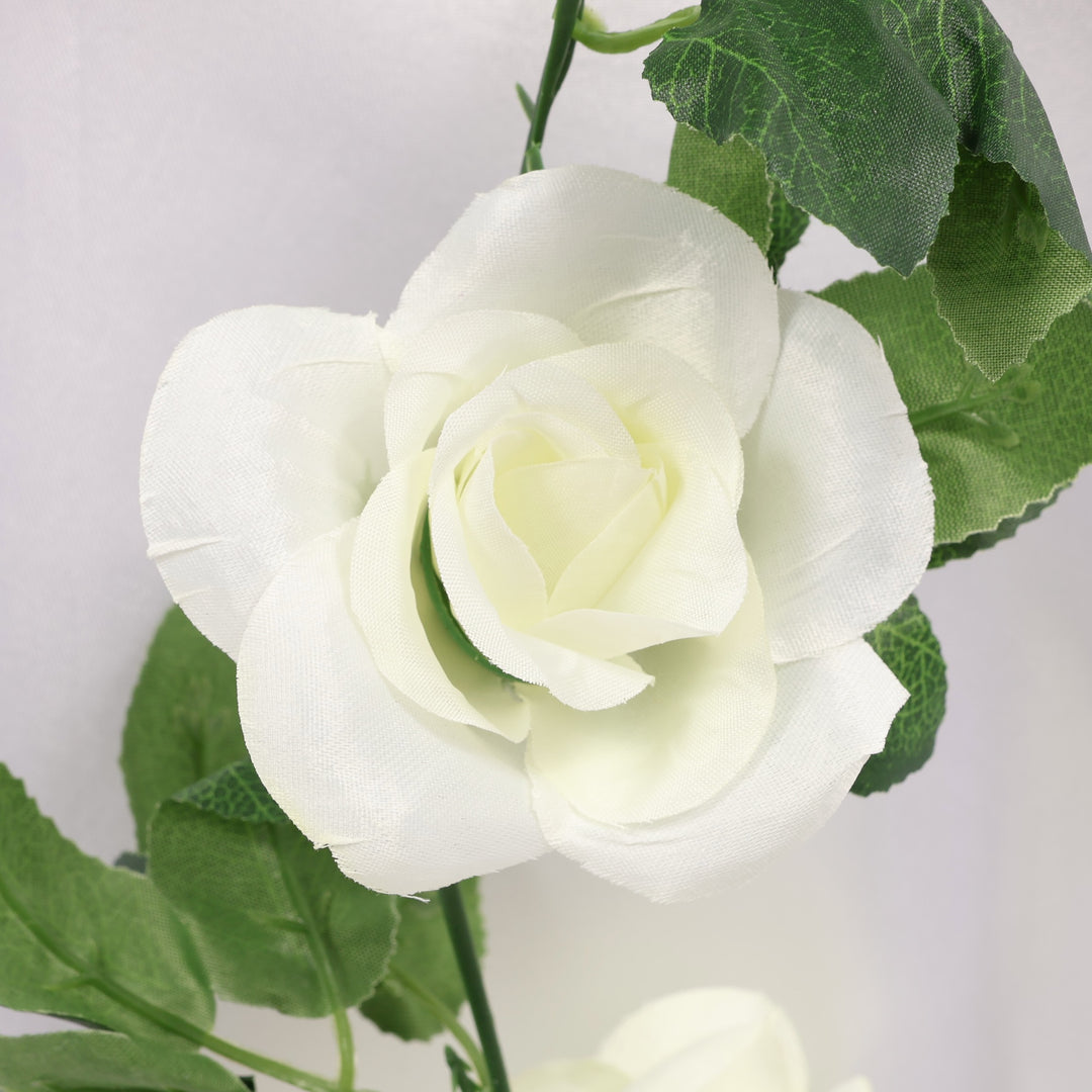 White rose with green leaves on a light gray background