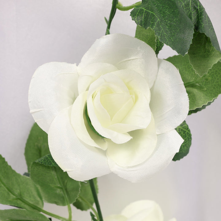 White rose with green leaves on a light gray background