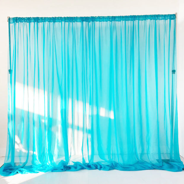 Aqua Blue voile curtain centre split with light shining 