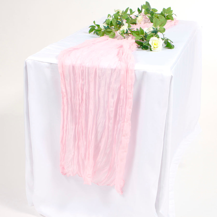 Light Pink Cheesecloth table runner on white tablecloth with white rose vine