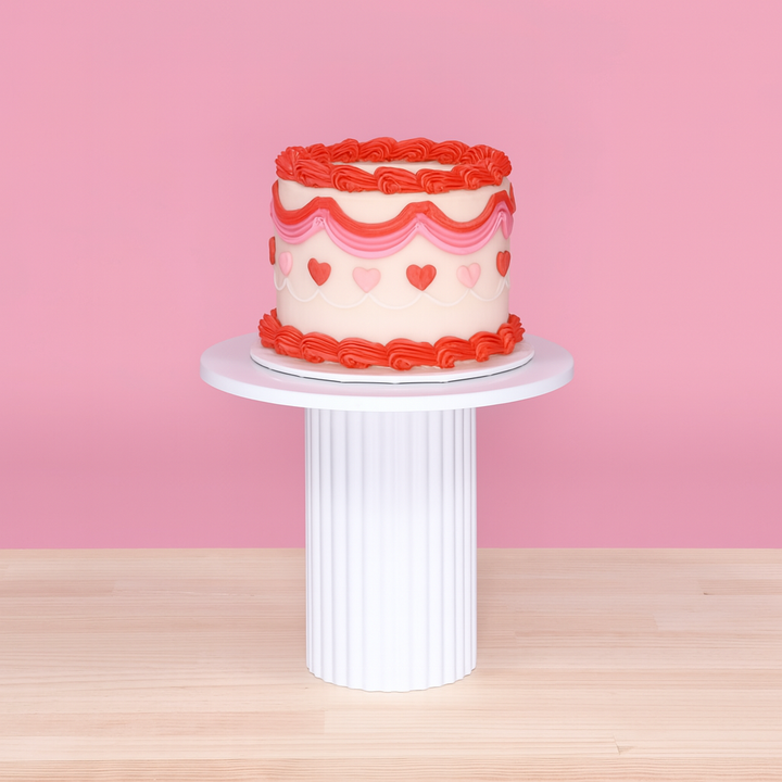 Cake Stand - Ribbed - White (25x20.5cm), pink background with small red and pink decorative cake on top
