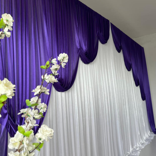 White ice silk backdrop with Purple contour swag ice silk behind white flowers