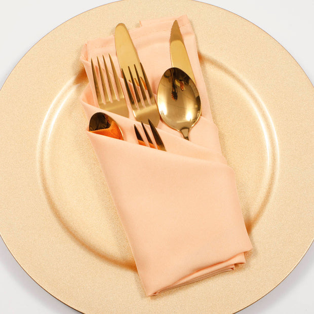 Peach napkin dining set with gold cutlery and Gold Charger Plate