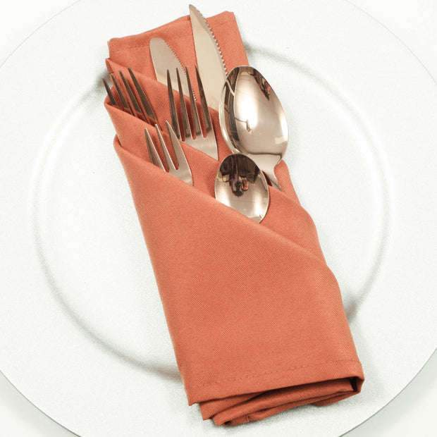Cloth Napkins - Terracotta (50x50cm) with rose gold cutlery set on a silver sparkly charger plate