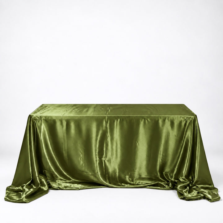 An olive green satin tablecloth draped over a rectangular table against a plain white studio background.