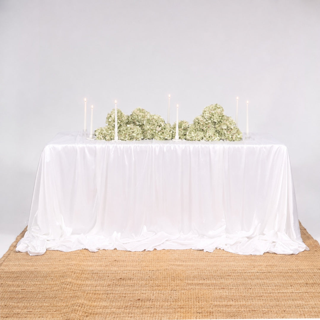 Ice Silk Satin Draping Tablecloth – White (1.5x3m), 3 tablecloths layered to cover 6ft table, with green hydrangeas and white taper candles