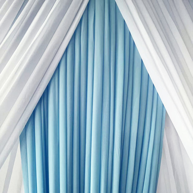 Layered chiffon curtain, white at back and light blue & white panels at front lied in centre close up