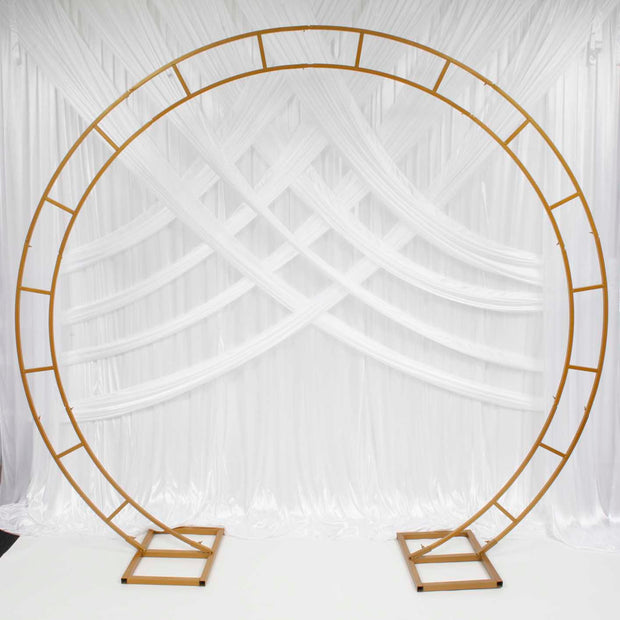 Gold Round Wedding Arch in front of white backdrop