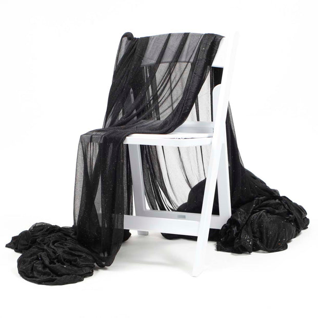 Black Chiffon Fabric with Glitter 1.5mx25m, draped over chair