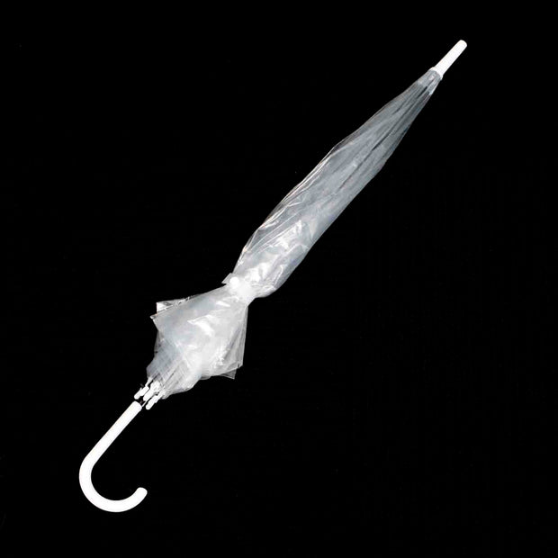 Closed transparent umbrella, tied up with the button tie. On a black background