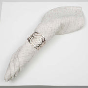 Ivory linen napkin rolled with silver rose cut out napkin ring