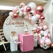 Pink Balloon Garland Setup with Plinths and cake stands