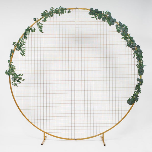 Large Gold Hoop Freestanding Wedding Arch with mesh inserts for hanging decorations. Decorated with Native Australian Eucalyptus leaf Greenery Garlands