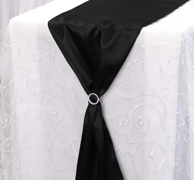 Sparkling buckle with black satin table runner