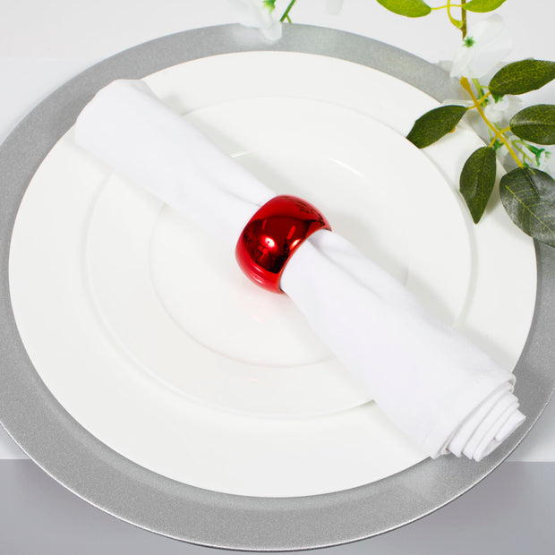 Glitter silver charger plate with white dinner plate, white napkin and red napkin ring on top
